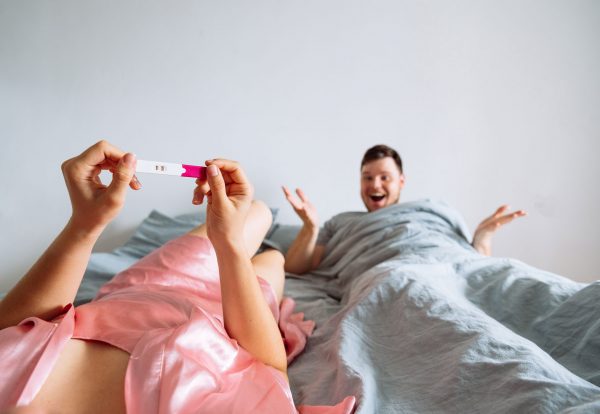 point-view-woman-looking-positive-pregnancy-test-man-slipping-background